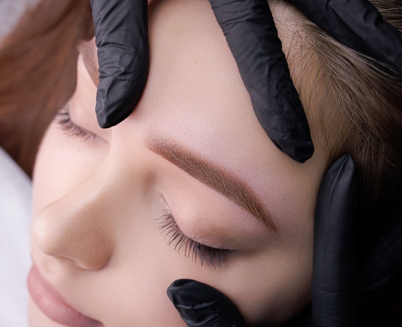 Close-up demonstration of permanent makeup after eyebrow design procedure Close-up demonstration of permanent makeup after eyebrow design procedure